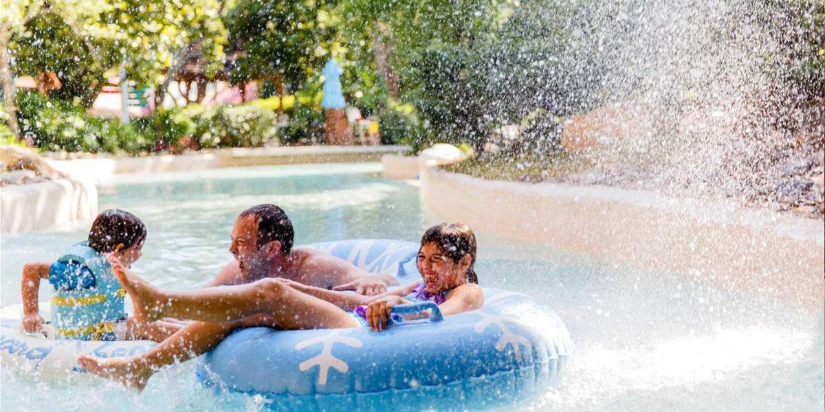 A family getting wet in a tube at Disney's Blizzard Beach Water Park.