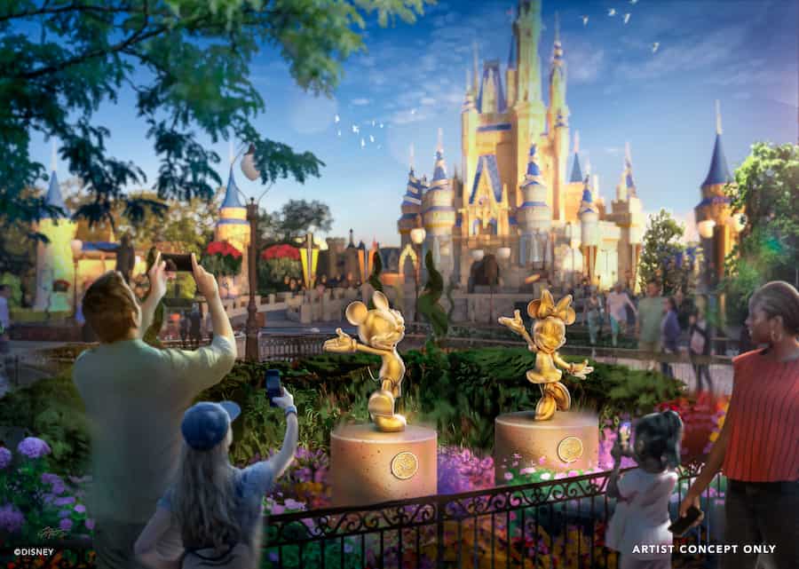 Guests snap photos of the Disney Fab 50 golden character statues, including Daisy Duck, displayed in front of Cinderella Castle at Walt Disney World, surrounded by vibrant park scenery.