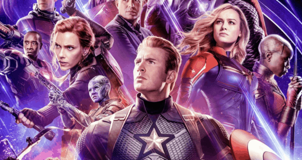 Marvel superheroes, including The Avengers and The Eternals, assembled in full costume with striking lighting and a cosmic backdrop, creating an epic photo opportunity for fans at a Marvel-themed attraction celebrating the ultimate Crossover Project.