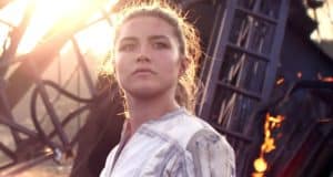 A heroic woman in a striking white suit strikes a powerful pose before a dramatic backdrop of burning wreckage, sunlight streaming behind her, evoking the action and charisma of Black Widow as seen in Marvel attractions.