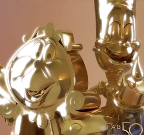Gold figures of Cogsworth and Lumiere beam with friendly smiles against a vibrant pink backdrop, capturing the magic and excitement of Disney World’s Fab 50 Character Collection alongside favorites like Daisy Duck.