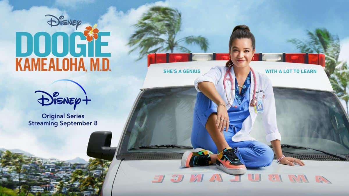 Doogie Kamealoha, M.D. sits in scrubs on the back of an ambulance, inviting Disney+ fans to stream her new medical series this September; the logo and title are prominently displayed.