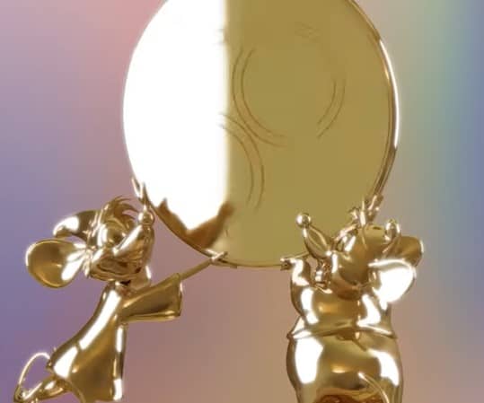 Mickey and Minnie Mouse, gleaming in gold, display a large golden coin together in front of a pastel rainbow backdrop—capturing the enchanting spirit of the Disney Fab 50 character sculptures unveiled during Walt Disney World's dazzling anniversary celebration.