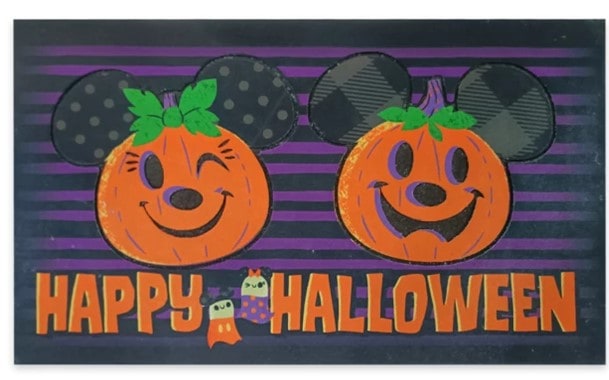 Mickey and Minnie Mouse-inspired jack-o'-lanterns, each with signature mouse ears and bows, are featured alongside “Happy Halloween” text and playful ghost graphics underneath. Part of shopDisney’s New Halloween collection, these festive decorations bring Disney Parks magic to your Halloween celebrations.