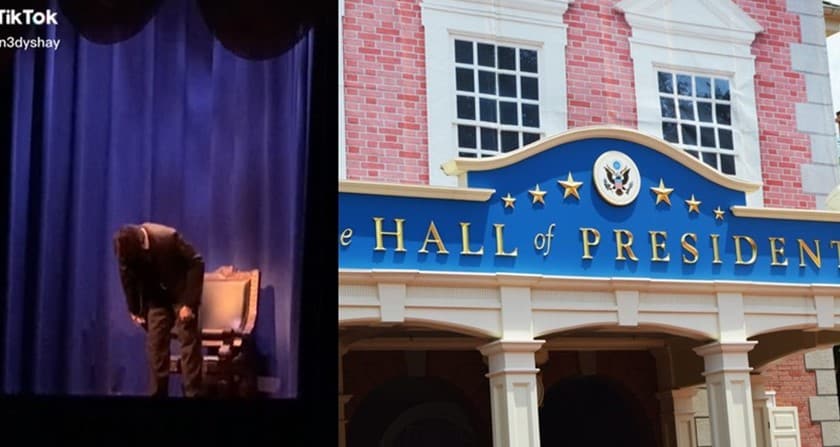Animatronic figure takes a bow onstage next to the iconic Hall of Presidents façade, highlighted by its elegant blue and gold signage, evoking the immersive spectacle found in Disney’s Animal Kingdom attractions.