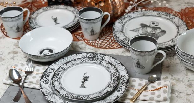 A captivating Nightmare Before Christmas-inspired kitchen set, designed in striking black and white, is displayed with park-worthy precision on a gleaming marble table—perfect for fans looking to bring the enchantment of Halloween Town into their home.
