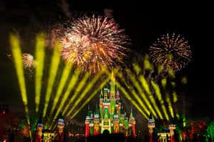 Dazzling fireworks and glowing yellow lights illuminate the night sky above Cinderella Castle during Disney Very Merriest After Hours, inviting guests to experience the enchanting holiday celebration now that tickets are available.