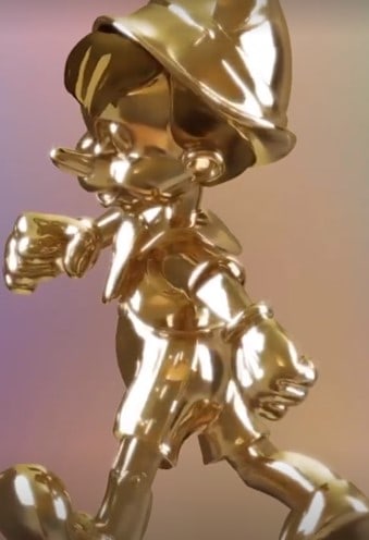 Pinocchio from the Disney Fab 50 Character Collection gleams in golden splendor, captured mid-step against a dreamy, softly blended backdrop.