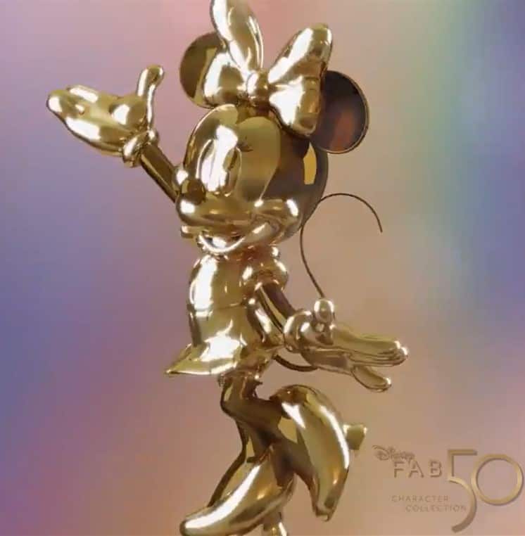 Minnie Mouse gleams in gold with her arms open wide at Disney World, a dazzling highlight of the Disney Fab 50 Character Collection.
