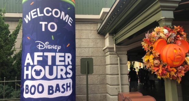 A tall banner announces "Welcome to Disney After Hours Boo Bash," alongside a festive Mickey pumpkin wreath, capturing the excitement and immersive atmosphere of this special after-hours celebration at Magic Kingdom.