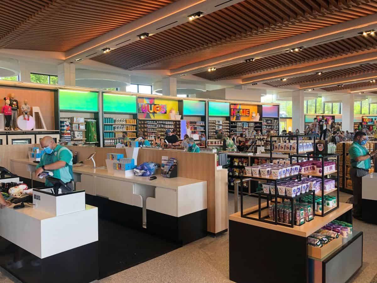 Creations Shop on Opening Day at EPCOT, bustling with Cast Members assisting guests at the registers and shelves stocked with colorful Disney merchandise—an ideal photo op for Disney fans.