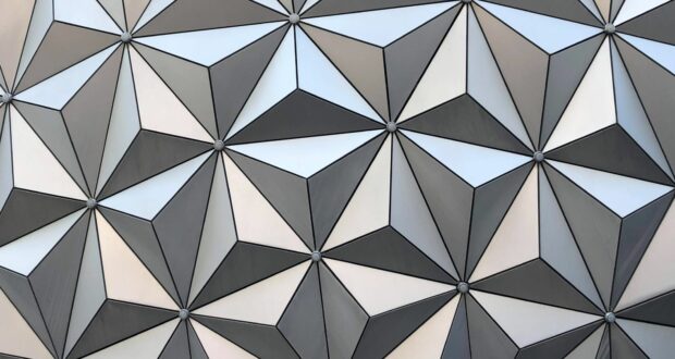 A futuristic 3D pattern of triangular tiles in silvery and gray tones, instantly evoking the iconic Spaceship Earth sphere at EPCOT, with its striking geometric design that Disney fans will recognize from the heart of the park.