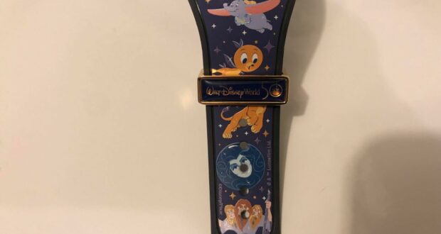 Disney World MagicBand featuring vibrant illustrations of Dumbo, Pumpkin, Pluto, Figment, and Simba—don’t forget to check your mailbox for this enchanting collectible!.
