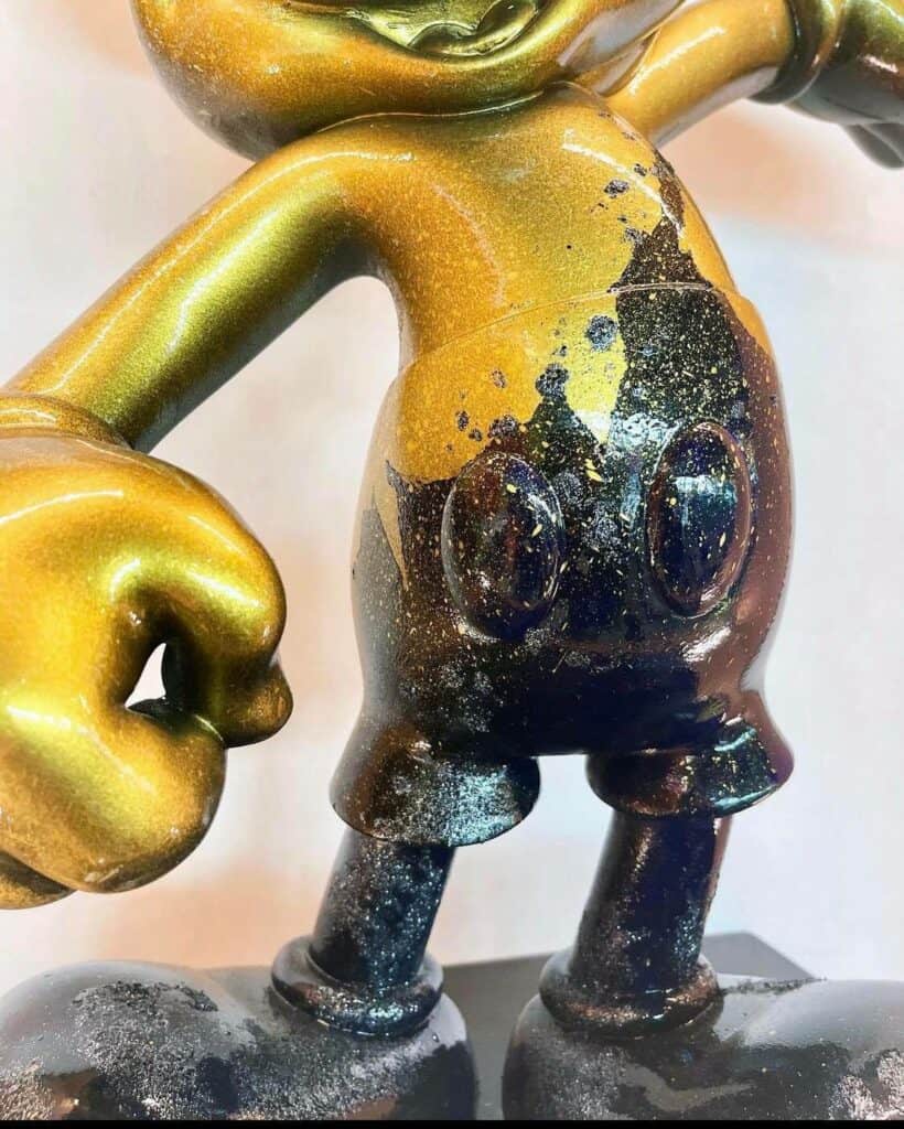 Gold and black statue of Mickey Mouse, featuring a shiny yet partially worn surface, displayed from the waist up—an eye-catching collectible for Disney fans at Mouse of Muse Creations Shop.