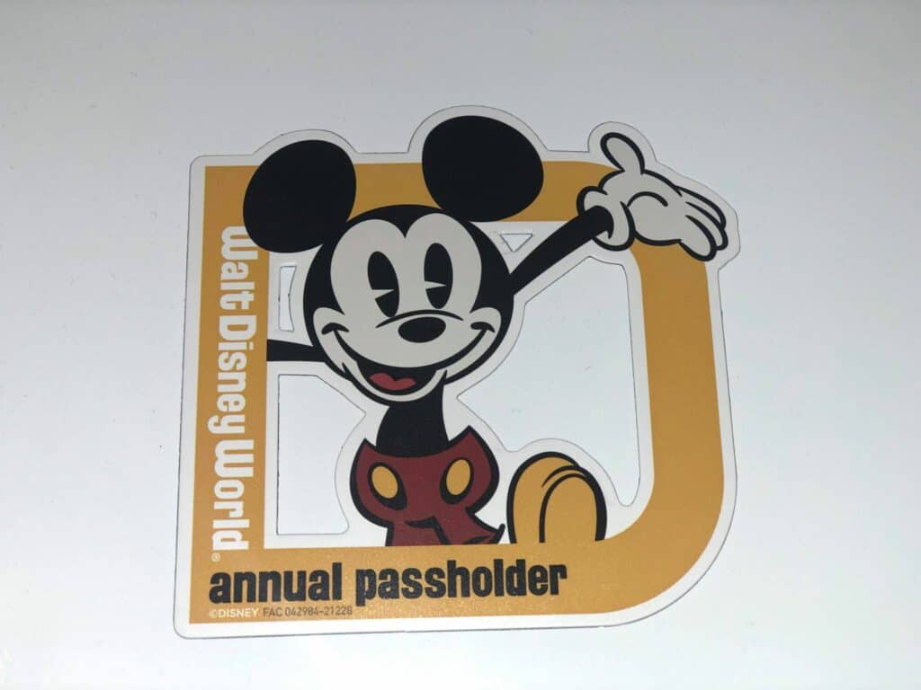 Mickey Mouse sticker featuring the "Walt Disney World annual passholder" logo in bold yellow and white—an exclusive nod for Disney fans eager to unlock more theme park magic.