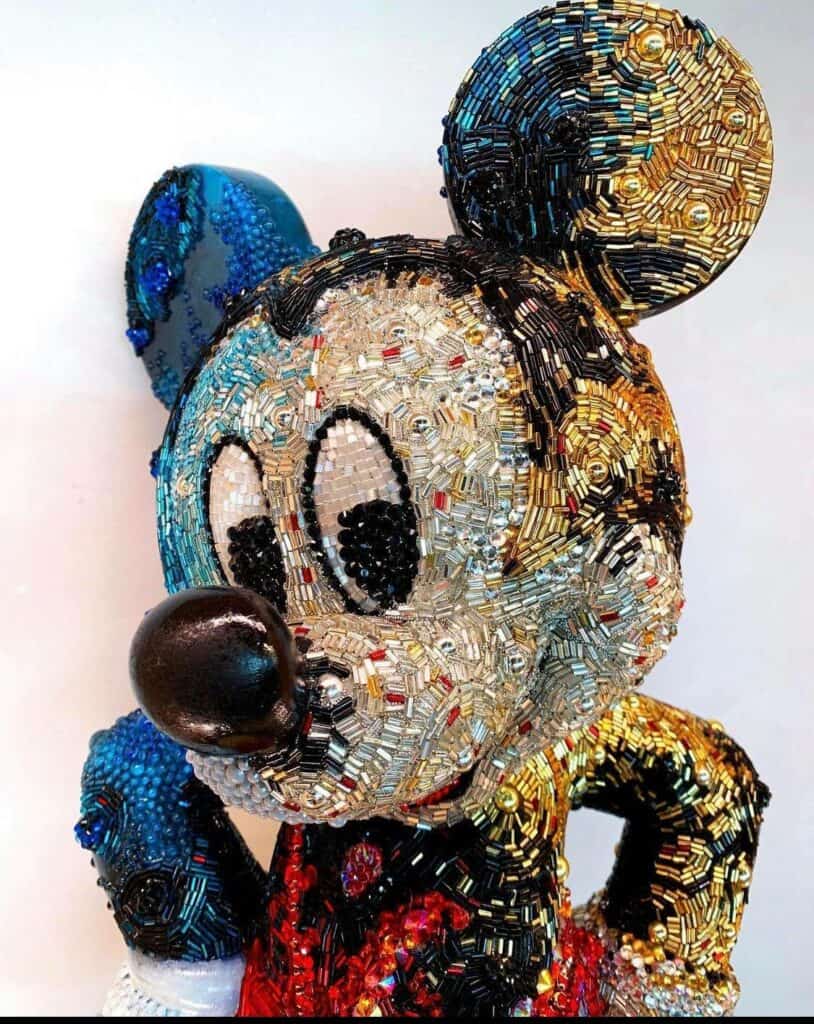 A colorful beaded sculpture of Mickey Mouse, adorned with vibrant beads and detailed patterns, brings playful Disney magic to any Creations Shop—showcasing the iconic whimsy that fans love at Walt Disney World.