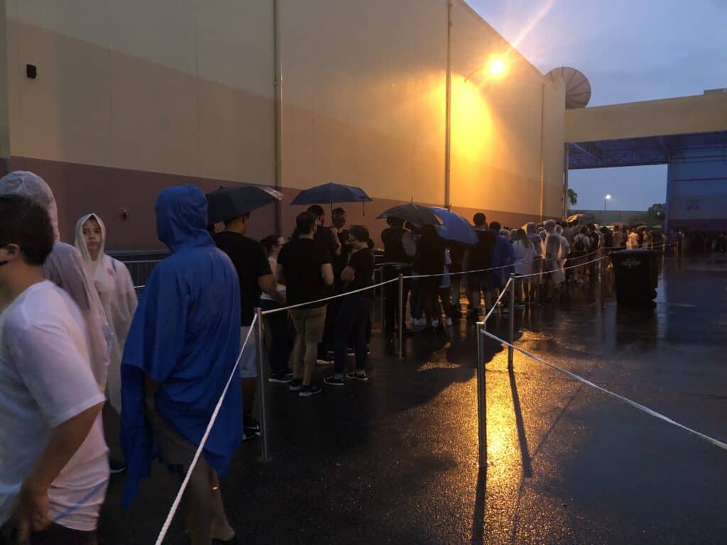 Guests eagerly line up at Universal Studios despite pouring rain, clutching umbrellas and sporting ponchos as they await the highly anticipated Rainy Opening of Halloween Horror Nights.