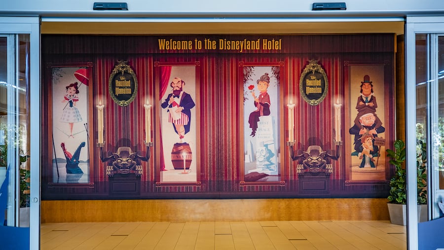 Colorful mural at the Disneyland Hotel entrance featuring stylized Disney character portraits and a bold "Welcome to the Disneyland Hotel" banner, inviting guests into an immersive Disney experience filled with exclusive hotel perks and signature sweet treats.