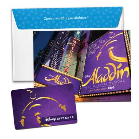 Aladdin musical gift card, themed envelope, and postcard featuring Broadway-style Disney Aladdin signage in the background, evoking the excitement of a Disney Parks entertainment experience.