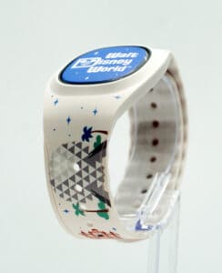 Disney World MagicBand+ in white with a bold geometric pattern, stars, and palm trees, showcased on a display stand—an eye-catching accessory that made its magical 2022 debut.