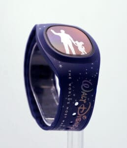 The 2022 Disney MagicBand+ showcases iconic silhouettes of Walt Disney and Mickey Mouse set against a dark blue, star-filled backdrop, capturing classic Disney magic for fans and theme park guests.