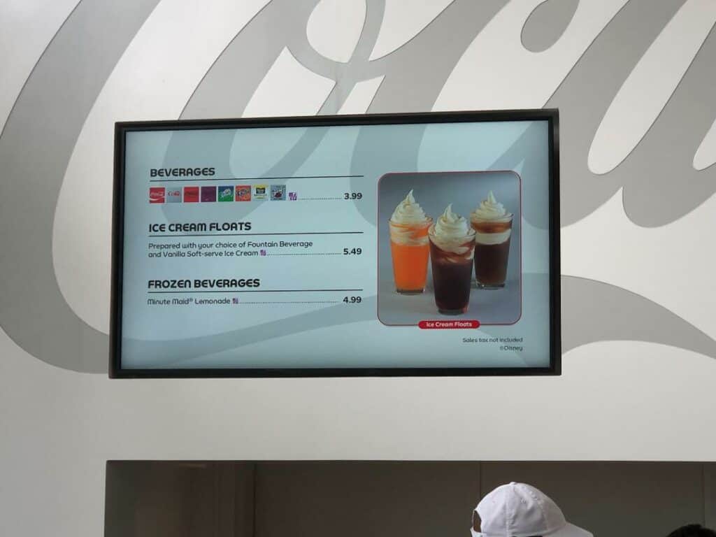 Epcot-themed digital menu showcasing colorful drink photos and fun, refreshing options like specialty beverages, ice cream floats, and frozen lemonades with prices—capturing the playful spirit of Club Cool at Disney World.
