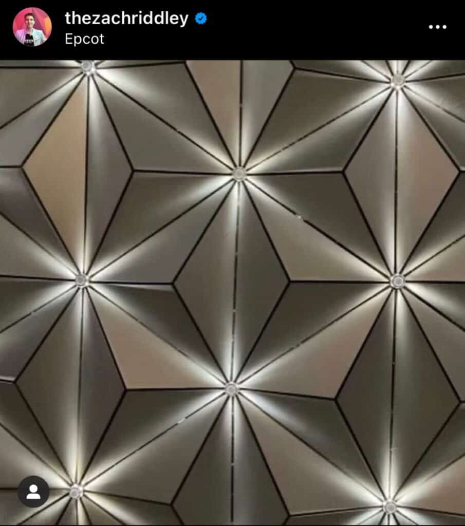 Spaceship Earth at Epcot illuminated with vibrant, colorful lights during the Beacons of Magic, showcasing its iconic geometric panels up close.