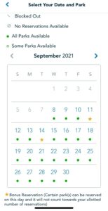 September 2021 Walt Disney World calendar displaying park reservation availability, featuring green dots for open dates and stars marking Bonus Reservations exclusive to Annual Passholders.
