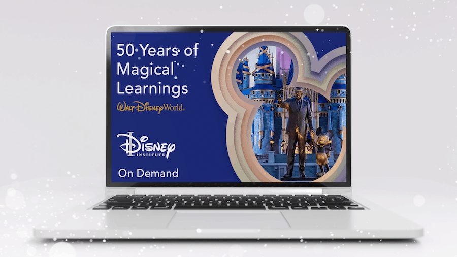 Laptop screen displays "50 Years of Magical Learnings" from Disney Institute, highlighting Cinderella Castle and the iconic Partners statue in tribute to Walt Disney World's rich history and entertainment legacy.