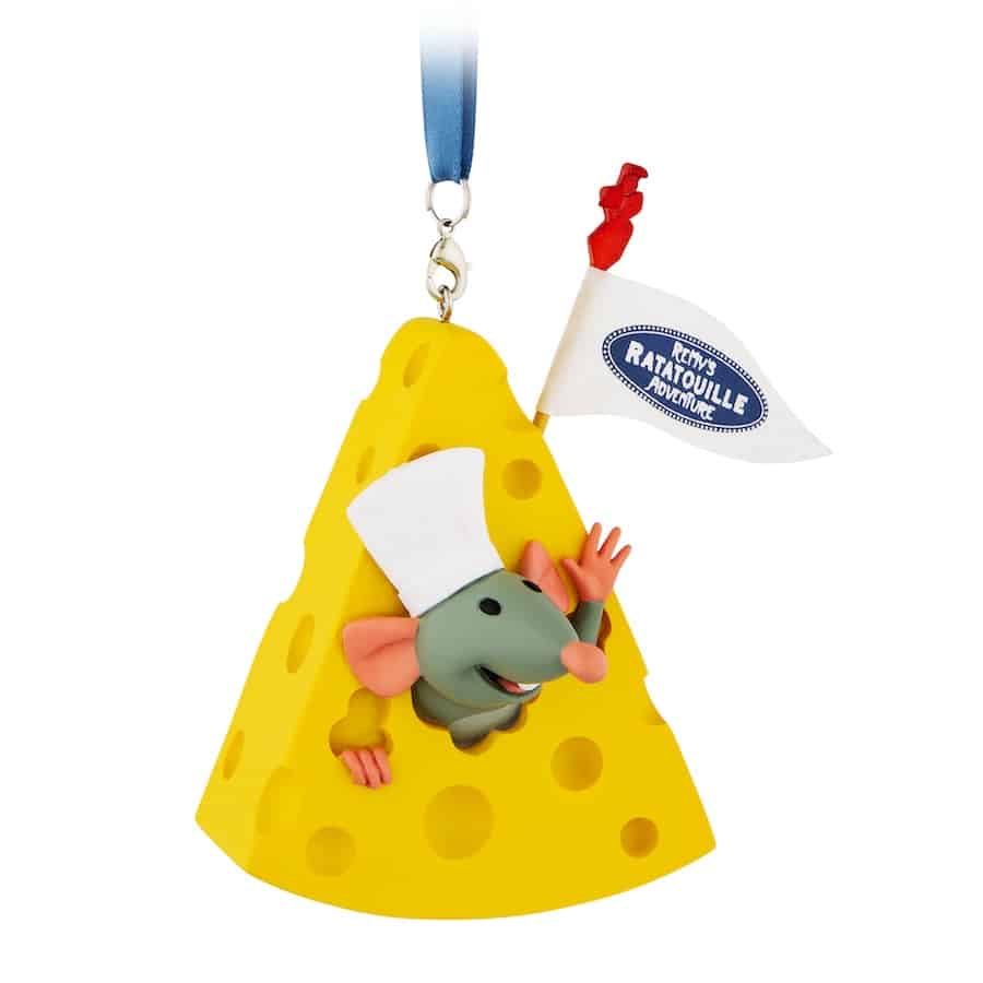 Remy, wearing his chef hat, waves from inside a Swiss cheese ornament topped with an interactive "Remy's Ratatouille Adventure" flag at EPCOT.