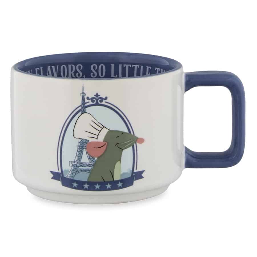 Remy from Ratatouille takes center stage on this stylish white mug with a blue rim, featuring the chef-hatted rat alongside the iconic Eiffel Tower—perfect for fans of Remy's Ratatouille Adventure at EPCOT and anyone wanting a dash of Parisian flair from the Disney Parks.