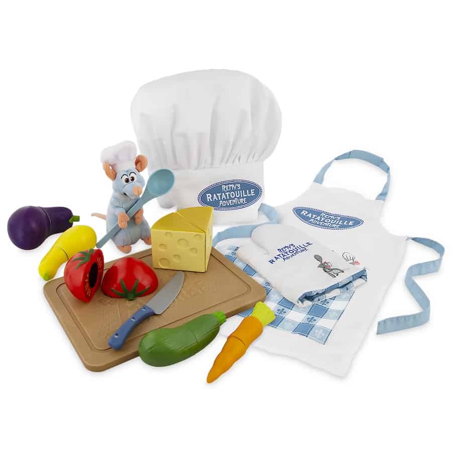 Ratatouille chef set featuring toy vegetables, a Remy mouse plush, interactive chef hat, apron, cheese, knife, and cutting board—an immersive collectible for Disney Parks guests and fans of Remy’s Ratatouille Adventure.