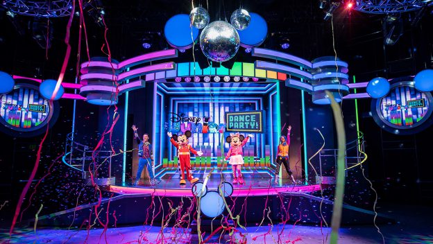 Mickey, Minnie, and their friends light up the stage with energetic dance moves, surrounded by vibrant balloons, sparkling streamers, and shining disco balls during the Disney Junior Dance Party at Disney California Adventure. Experience the excitement when the party begins October 15!.