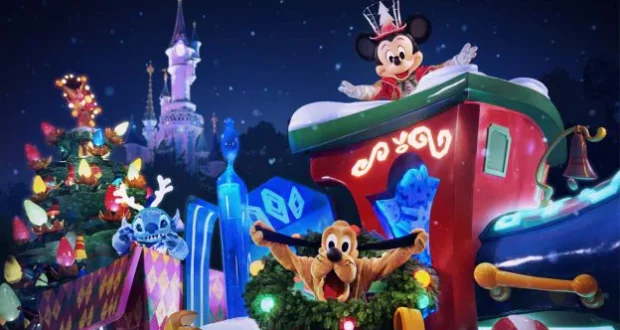 Mickey Mouse wearing a sparkling crown, Pluto, and Stitch join the Christmas festivities on a dazzling holiday parade float near a beautifully decorated tree at Disneyland Paris, spreading magical cheer to the crowds.