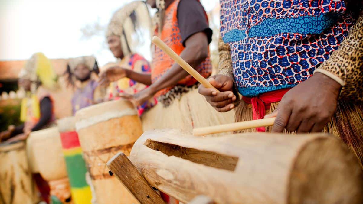 The Tam Tam Drummers bring vibrant rhythms and energetic dancing to Harambe with a colorful outdoor performance, captivating guests on November 7th.