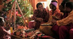 Five friends in festive pajamas enjoy holiday crafts and treats together by a sparkling Christmas tree, as their living room looks ready for a magical winter celebration straight out of Main Street, U.S.A.