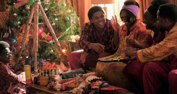 Five friends in festive pajamas enjoy holiday crafts and treats together by a sparkling Christmas tree, as their living room looks ready for a magical winter celebration straight out of Main Street, U.S.A.