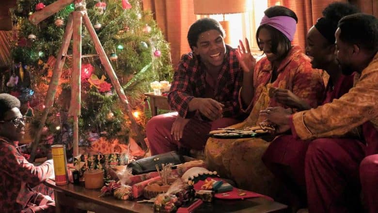 Five friends in festive pajamas enjoy holiday crafts and treats together by a sparkling Christmas tree, as their living room looks ready for a magical winter celebration straight out of Main Street, U.S.A.