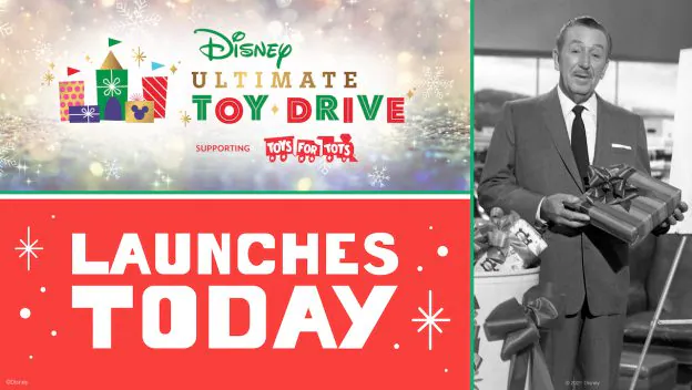 The Disney Ultimate Toy Drive kicks off today at Disney Parks, spreading holiday magic for Toys for Tots; a dapper Cast Member in a classic suit carries beautifully wrapped gifts, capturing the joyful giving spirit of this beloved Disney tradition.