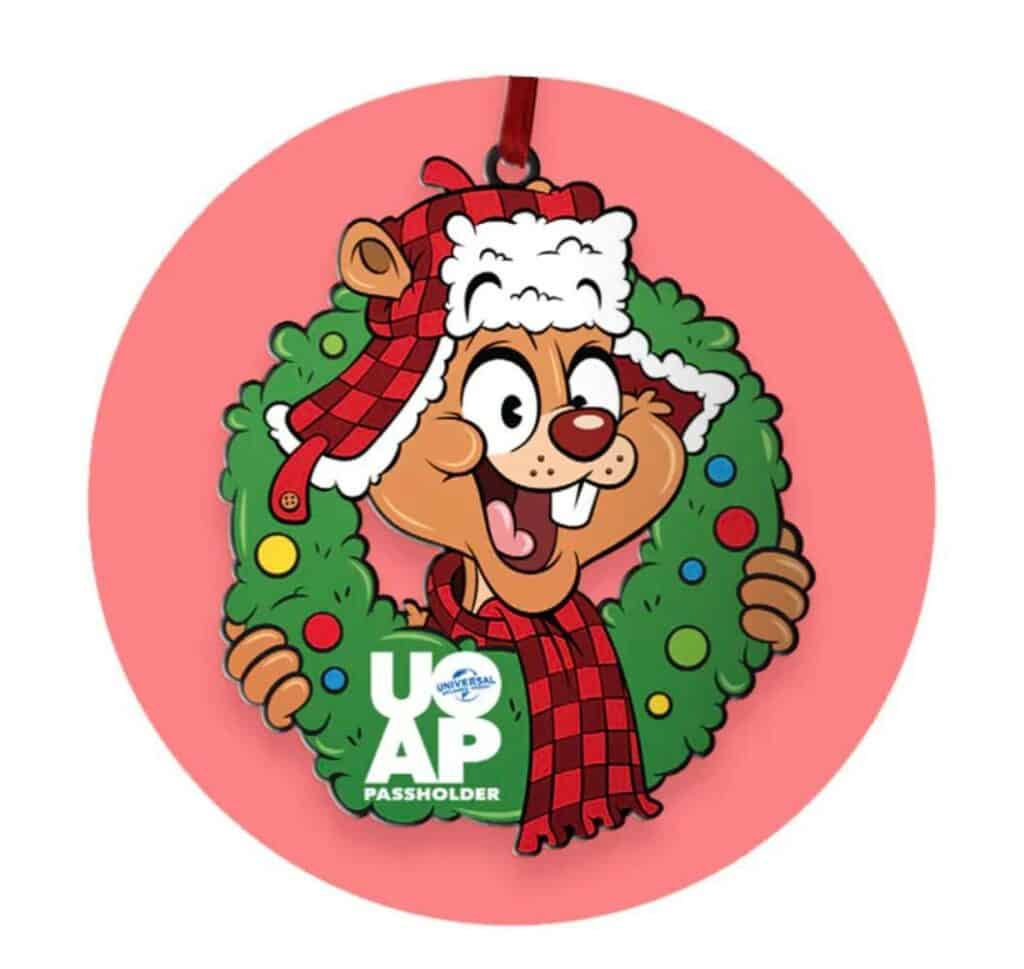 A cartoon chipmunk sporting a plaid trapper hat peeks playfully through a Christmas wreath against a bold red backdrop, perfectly embodying the cheerful Holiday Passholder Perks atmosphere at Universal Studios Orlando.