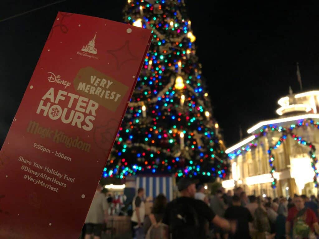 A Disney Very Merriest After Hours ticket is showcased in front of the sparkling Magic Kingdom Christmas tree at night.