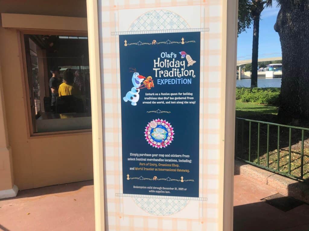 Olaf’s Holiday Tradition Expedition sign displayed at EPCOT, featuring festive instructions and a cheerful Olaf graphic, inviting guests to join the fun as part of the EPCOT International Festival of the Holidays.
