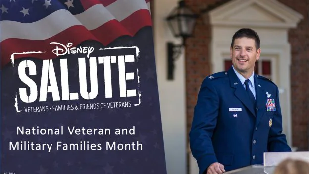 A member of the U.S. military stands at a podium beside a Disney Salute sign during Veterans and Military Families Month festivities, celebrating military heritage at Walt Disney World.