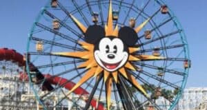 Mickey’s Fun Wheel at Disney California Adventure Park, featuring a giant Mickey Mouse face on its centerpiece, standing tall against a bright blue sky.