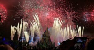 Dazzling fireworks light up the night sky above Cinderella Castle at Magic Kingdom during Christmas Week, as excited guests gather to watch and capture the magical display. The festive atmosphere echoes the joy of Mickey’s Once Upon a Christmastime Parade, creating unforgettable holiday memories throughout Walt Disney World Resort.