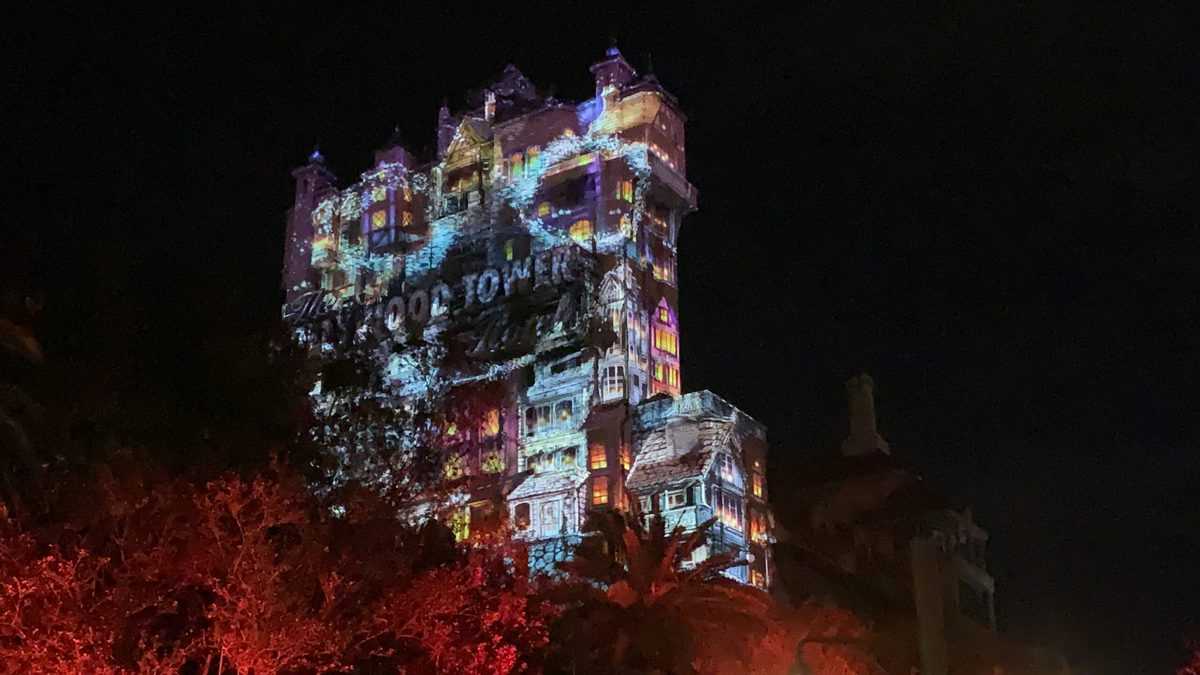 Hollywood Tower Hotel glows with vibrant lights and dazzling projections during Sunset Seasons Greetings, creating a magical nighttime spectacle that draws fans and guests into the excitement at Disney’s Hollywood Studios.