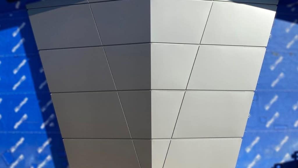 A futuristic silver structure with sharp angles and panel detailing, set against a vibrant blue patterned backdrop—evoking the high-tech, cosmic style of Guardians of the Galaxy: Cosmic Rewind at EPCOT.