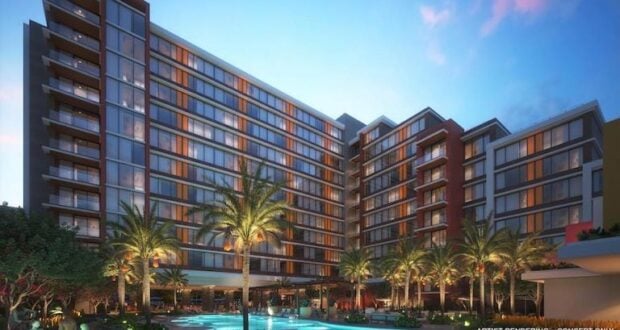 A vibrant, multi-story Disney World resort with a sparkling pool, swaying palm trees, and twinkling lights at sunset—an inviting retreat after an action-packed day in the parks. This resort is a top choice for guests planning their magical Disney adventure.