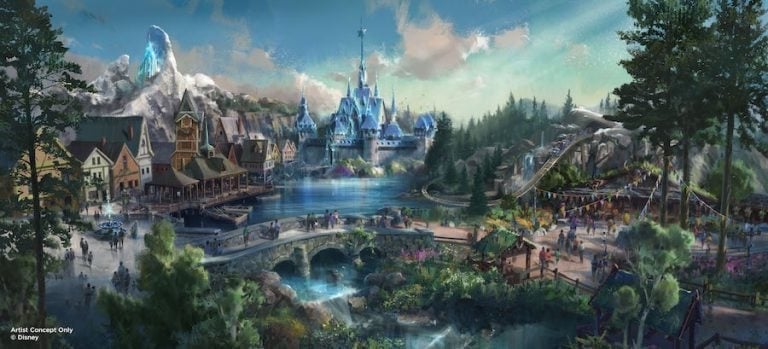 A magical village scene featuring a sparkling lake, a charming bridge, and an iconic blue castle nestled among mountains and lush trees, capturing the immersive wonder and fairy tale ambiance found in Disney Parks.