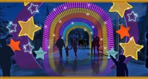 Guests stroll through a vibrant rainbow-lit tunnel, accented by glowing yellow stars, during Give Kids The World Village’s Night of a Million Lights—an immersive holiday spectacle that lights up the night and delights theme park fans of every age.